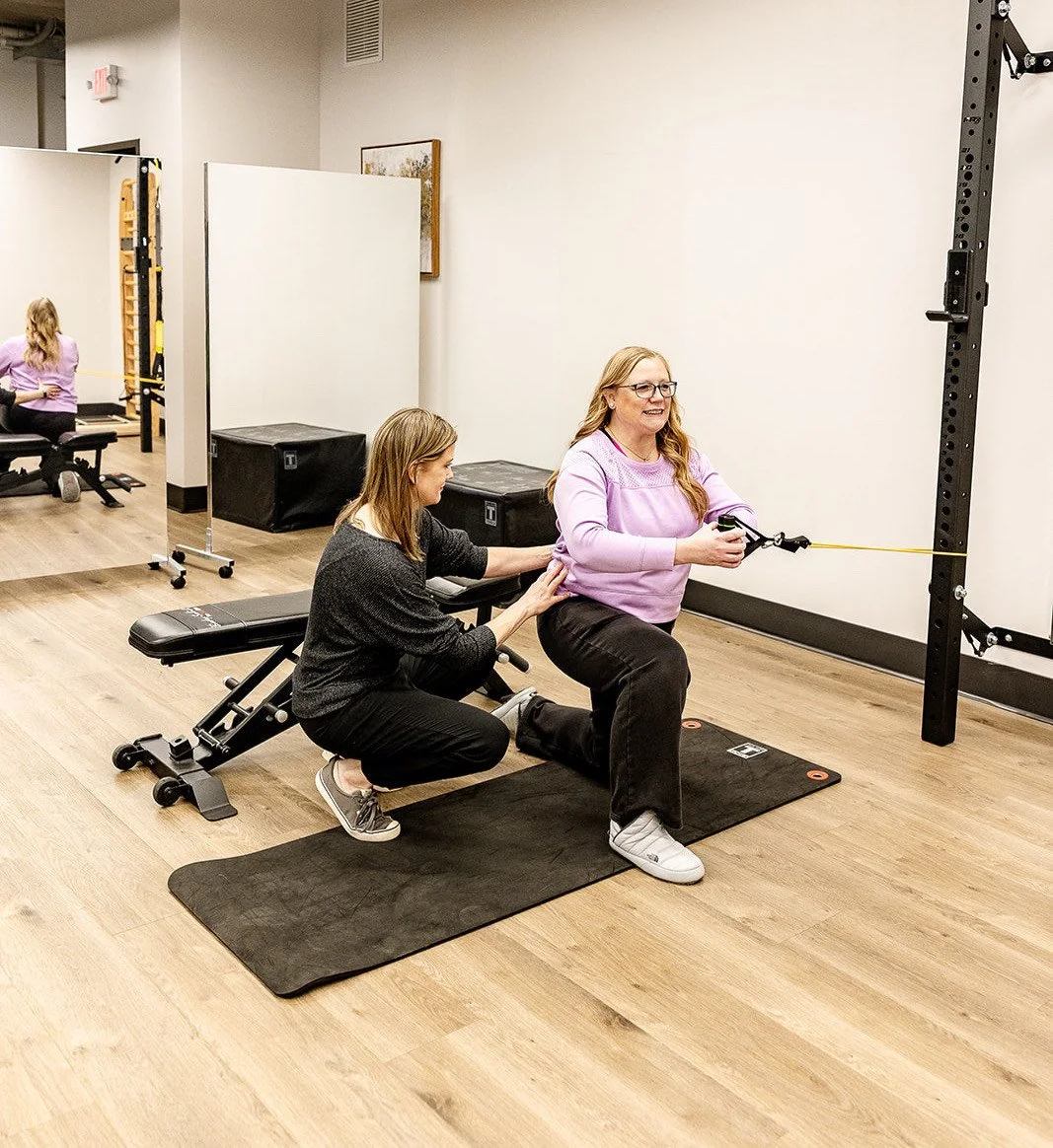 Dr. Bethany Hansen coaching a patient through resistance-band exercise