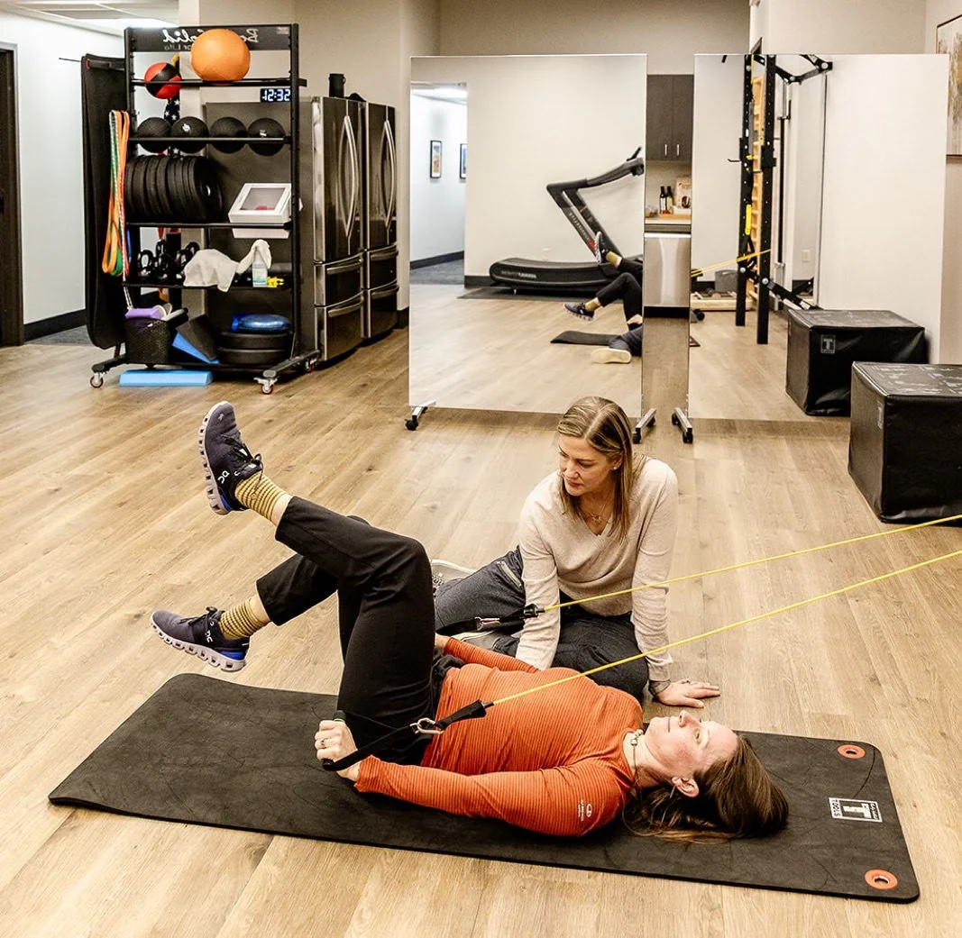 Dr. Bethany Hansen guiding a patient through resistance-band exercises